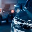 Selective focus grey car parked in luxury showroom. Car dealership office. New car parked in modern showroom. Car for sale and rent business concept. Automobile leasing and insurance background.