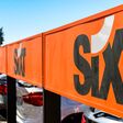 Naples, Italy - August 2019: Sign outside the Sixt car rental depot at Naples airport.