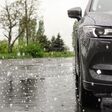 Modern car parked outdoors on rainy day with hail