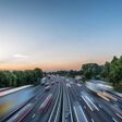 Sunset view heavy traffic moving at speed on UK motorway in England.