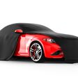 Modern red sports car presentation with black cloth: 3D illustration