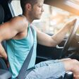 Man with lots of back pain after a long drive in car