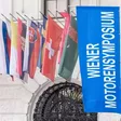 Wiener Motorensymposium Banner neben internationallen Flaggen