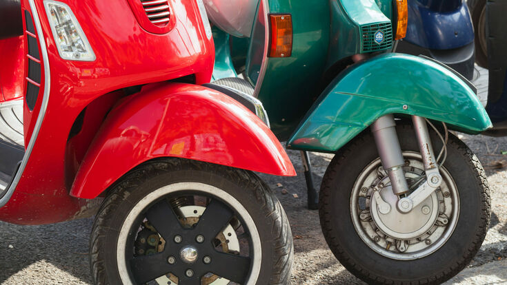 © stock.adobe vespa scooter old vintage retro row parking roadside road wheels transportation city urban small italy italian motorcycle motor style street classic old-fashioned motorbike moped transport parked vehicle bike retro-styled piaggio traditional red green blue colorful fragment brake black asphalt logo